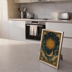 Celestial sun and moon wall art print framed and displayed in a modern home interior.