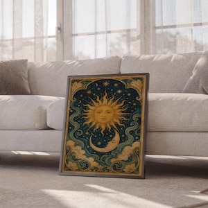Celestial sun and moon wall art print leaning against a white sofa in a bright living room with sheer curtains.