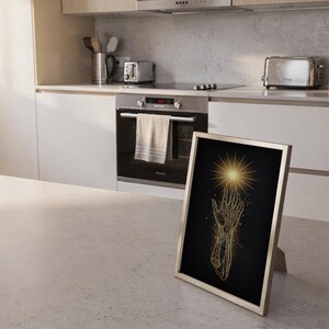 Celestial hand wall art print framed and displayed in a modern home interior.