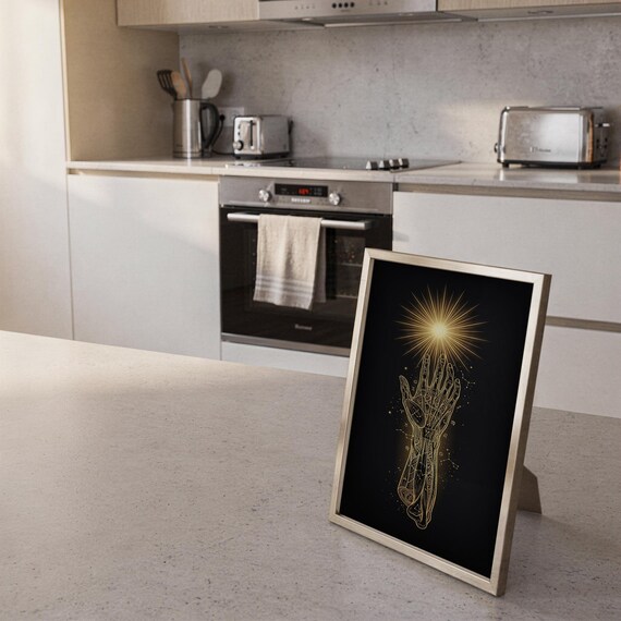 Celestial hand wall art print framed and displayed in a modern home interior.