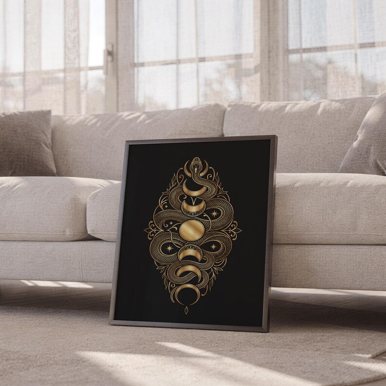 Gold snake moon phase wall art print leaning against a white sofa in a bright living room with sheer curtains.