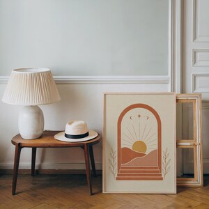 Terracotta arch boho landscape print framed on wooden side table in bright living room