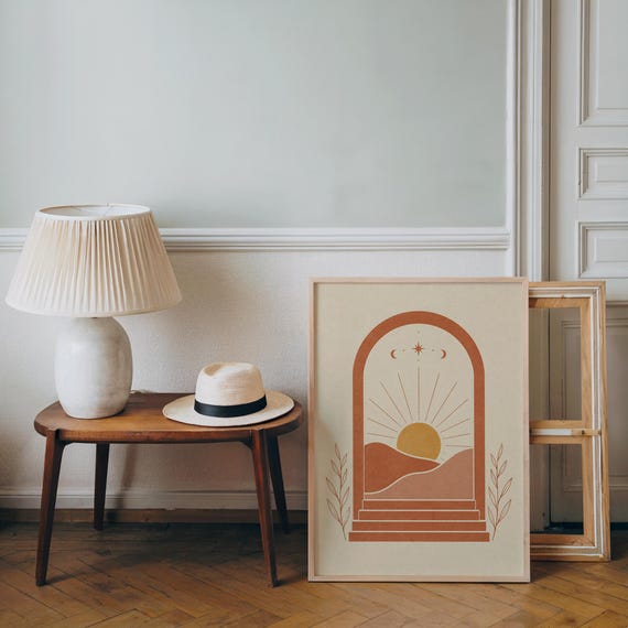 Terracotta arch boho landscape print framed on wooden side table in bright living room