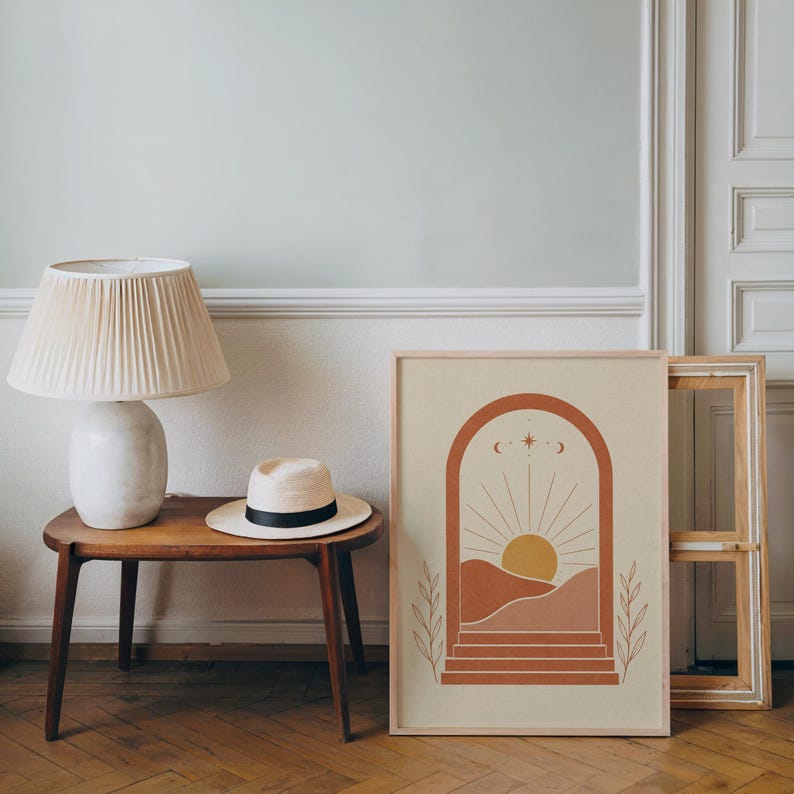 Terracotta arch boho landscape print framed on wooden side table in bright living room