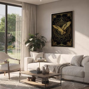 Celestial owl wall art print hanging above a white sofa in a living room with garden views.
