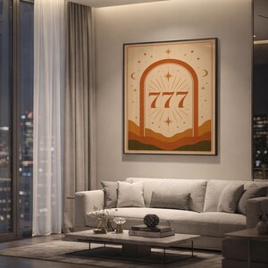 Framed 777 celestial lucky number art print hanging above a modern beige sofa in a luxury apartment living room with city night view.
