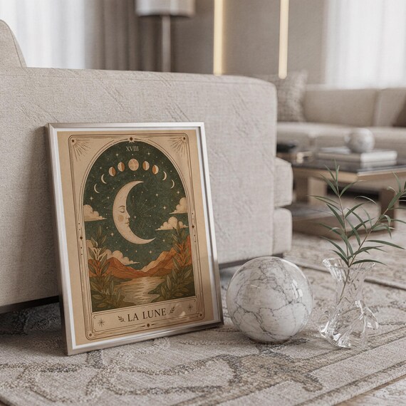 Spiritual celestial moon poster framed on carpet floor next to crystal ball decor in home.