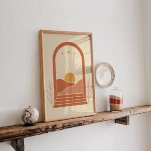 Boho terracotta desert print resting on rustic wooden wall shelf
