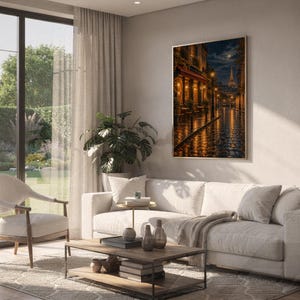 Paris eiffel tower wall art print hanging above a white sofa in a living room with garden views.