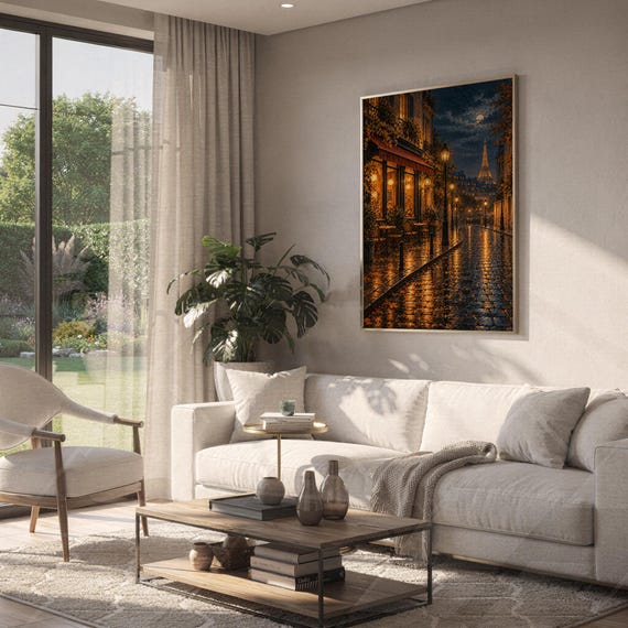 Paris eiffel tower wall art print hanging above a white sofa in a living room with garden views.