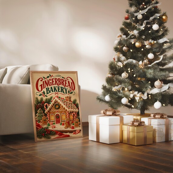 Gingerbread bakery christmas wall art print in a silver frame leaning against a sofa beside a decorative marble sphere.