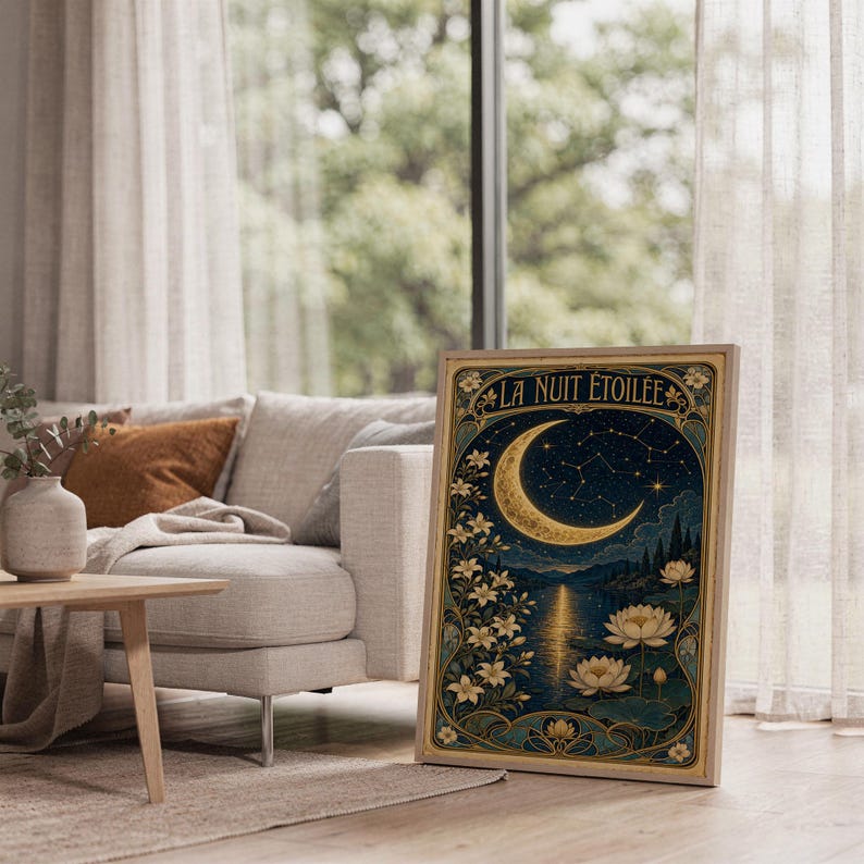 A framed Art Nouveau moon poster stands on a wooden floor in a sunlit room next to a sofa.