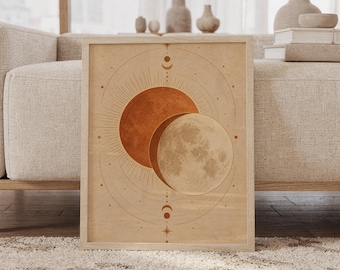 May include: A framed rectangular wall art print featuring a celestial illustration of a rust-colored sun overlapping a textured beige moon. The design includes thin gold-toned geometric lines, starburst accents, and small crescent moon symbols on a tan background.