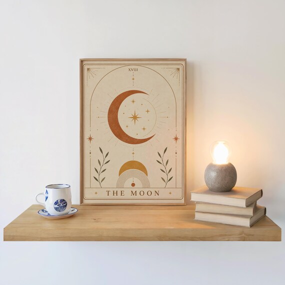 Bohemian moon art print on wooden floating shelf next to coffee cup and candle decor.