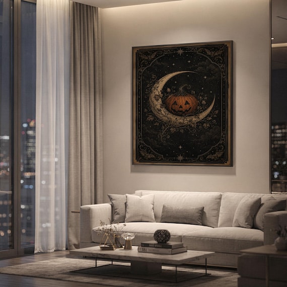 Vintage halloween moon wall art print hanging above a light gray sofa in a modern living room with evening city views through tall windows.