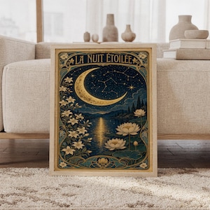 A framed Art Nouveau moon print leaning against a light gray sofa.