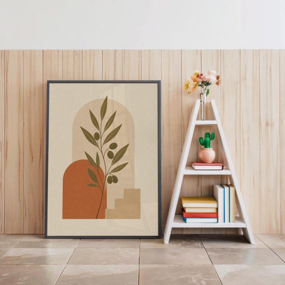 Olive branch print in black frame next to bohemian decorative ladder