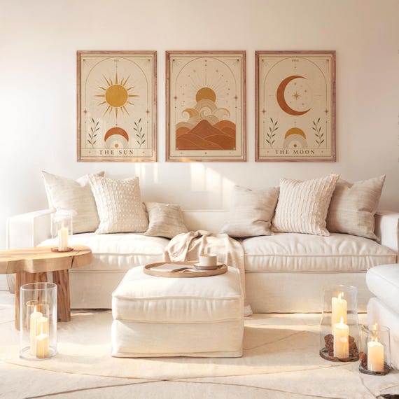 Set of 3 framed sun and moon tarot art prints hanging above a white sofa in a sunlit living room.