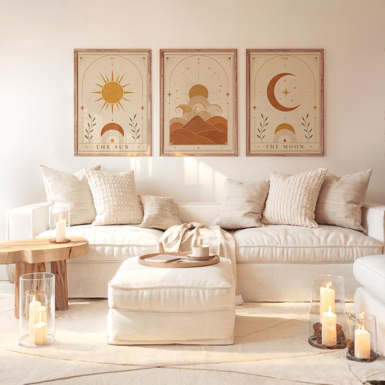 Set of 3 framed sun and moon tarot art prints hanging above a white sofa in a sunlit living room.