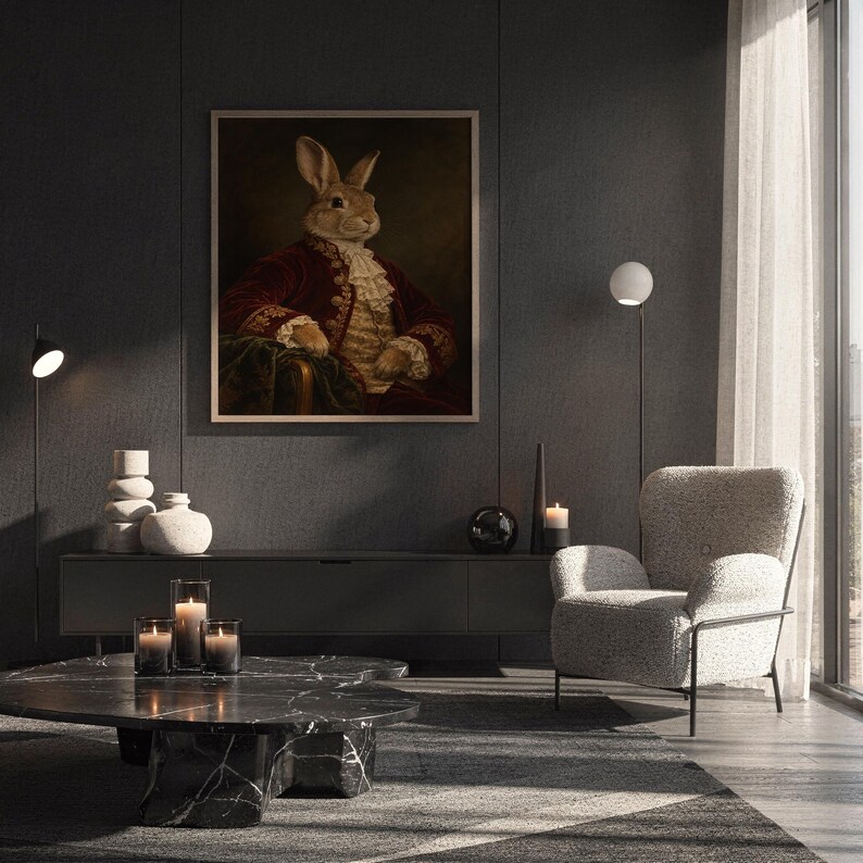 Regal rabbit portrait wall art print hanging above a white sofa in a living room with garden views.