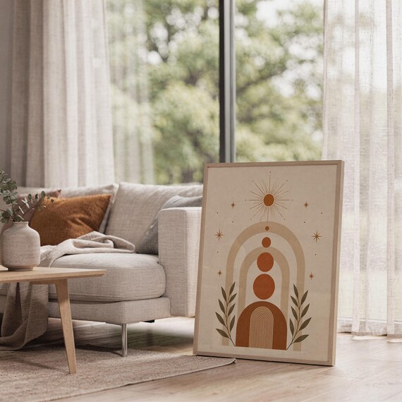 Boho geometric arch print framed on bright sunlit living room floor next to window.