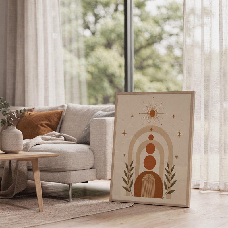 Boho geometric arch print framed on bright sunlit living room floor next to window.