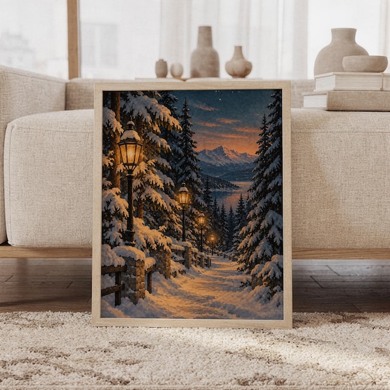 Snowy forest path wall art print featuring deep midnight blue skies, snow-covered pine trees, glowing golden lanterns, and distant mountain peaks in a painterly winter landscape style, framed and leaning against a beige sofa on a textured rug in a bright Scandinavian living room.
