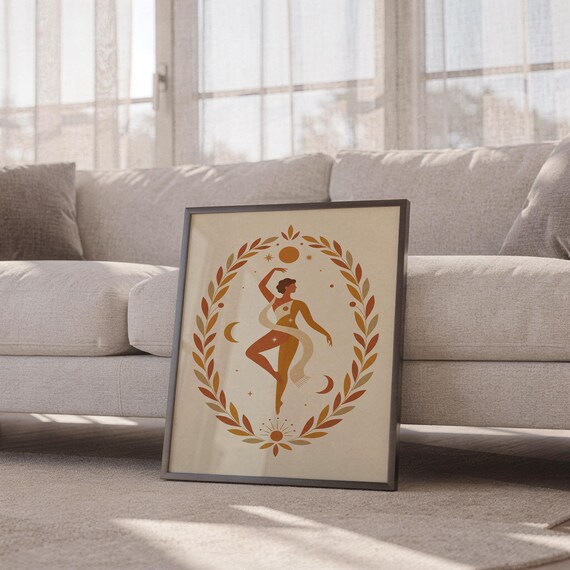 Boho botanical dancer poster in a thin frame sitting on the carpet in front of a cozy white sofa in a bright living space.