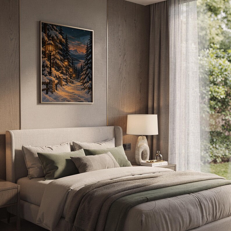 Snowy forest path wall art print hanging above a bed with sage green pillows in a calm neutral bedroom.