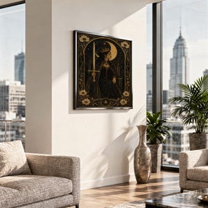 Gothic moon queen wall art print standing on a white kitchen counter beside potted herbs.