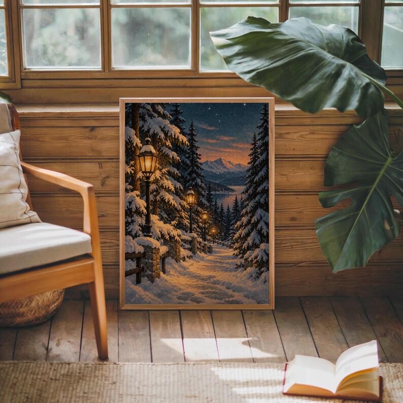 Snowy forest path wall art print leaning against warm wood paneling beside a wooden armchair and a monstera plant.