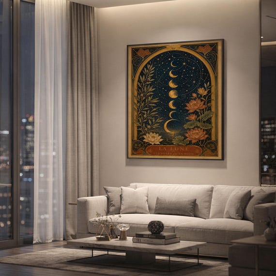 Moon phase wall art print hanging above a light gray sofa in a modern living room with evening city views through tall windows.