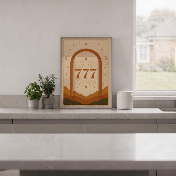 Boho 777 angel number decor framed and displayed on a sleek kitchen countertop with potted herbs.