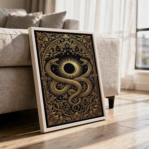 Occult snake wall art print in a white frame leaning against a gray sofa on a sunlit wooden floor.