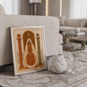 Framed minimalist pottery arch art leaning on the floor near a light beige sofa and decorative marble sphere.