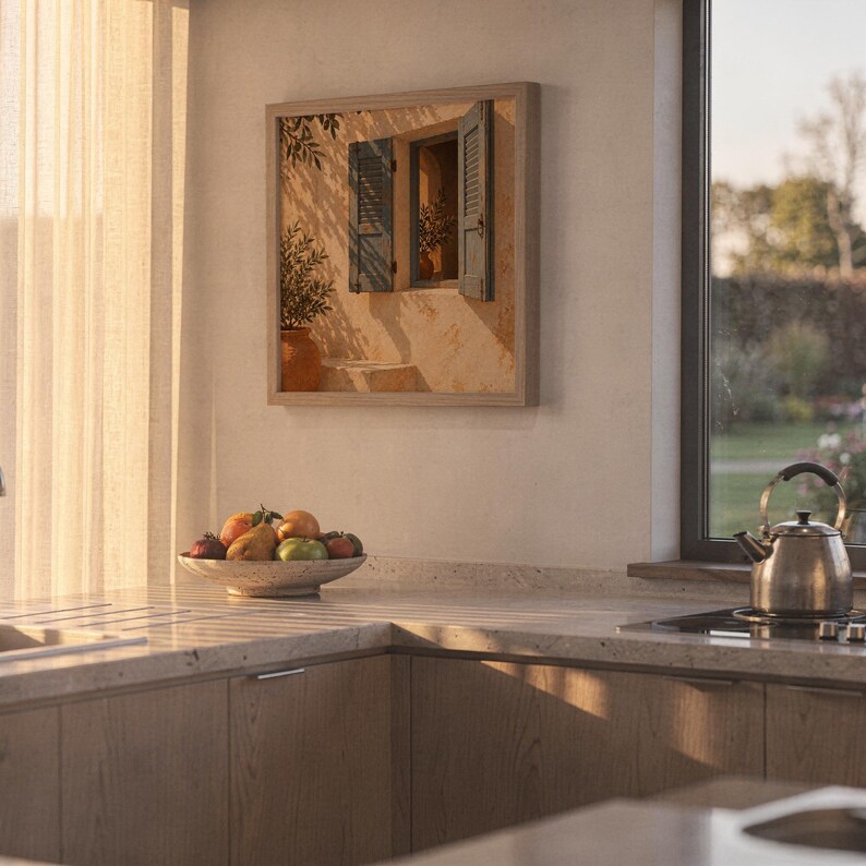 Mediterranean blue shutter wall art print hanging above a stone countertop with a fruit bowl in a sunny kitchen.