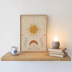 Modern bohemian sun wall print framed on shelf next to coffee cup and diffuser
