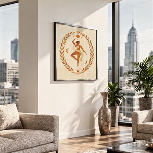 Framed terracotta dancing woman poster hanging on the wall of a bright high-rise living room overlooking city skyscrapers.