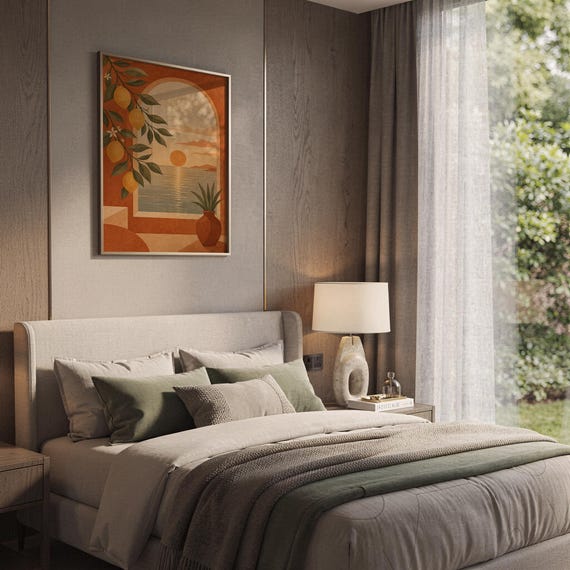 Mediterranean lemon and sea view arch print hanging above a bed with sage green pillows in a calm neutral bedroom.