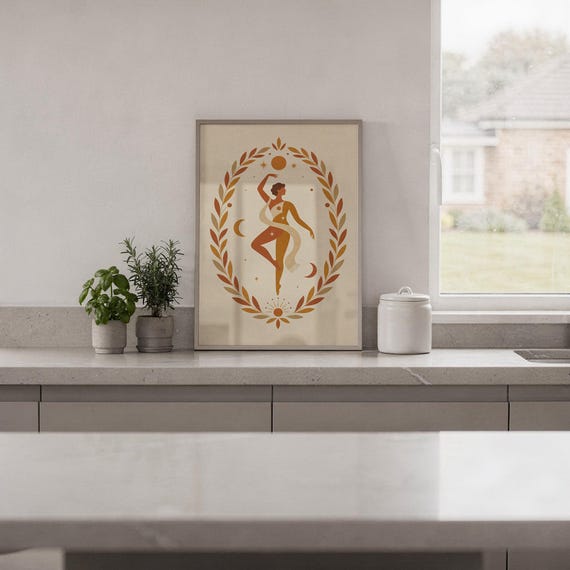 Boho celestial dancing figure decor framed and displayed on a sleek kitchen countertop with potted herbs.