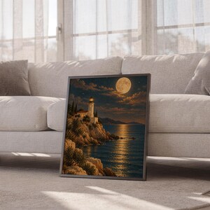 Moonlit lighthouse wall art print leaning against a white sofa in a bright living room with sheer curtains.