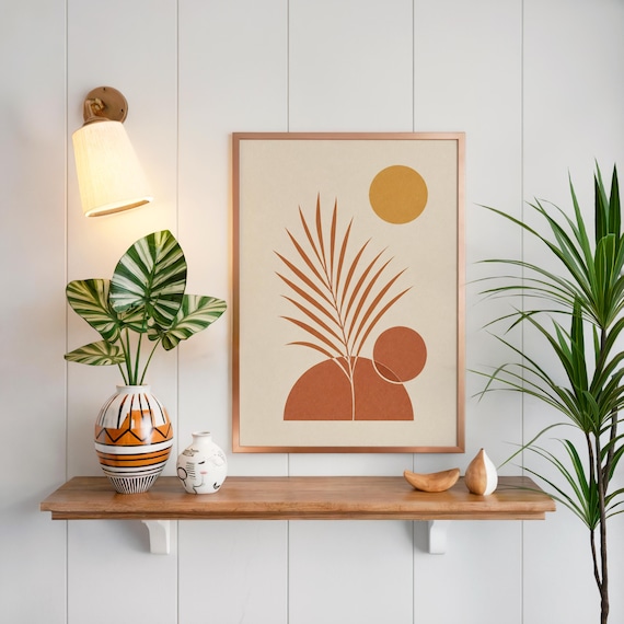 Boho palm leaf wall art on floating wooden shelf above lush green houseplants