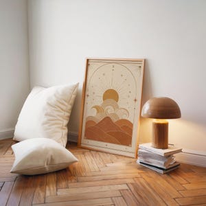 Terracotta boho wave poster on parquet floor with white pillows and floor lamp.