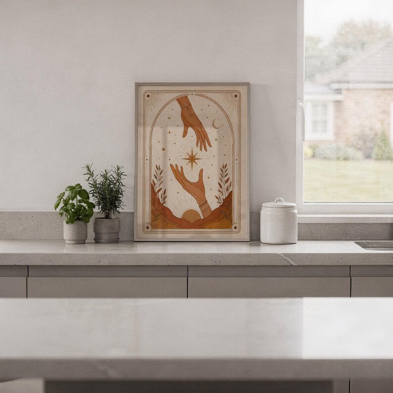 Minimalist spiritual hands tarot print framed on white kitchen counter against clean wall decor.