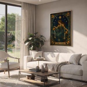 The star tarot card wall art print hanging above a white sofa in a living room with garden views.
