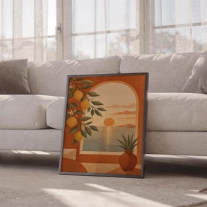 Mediterranean lemon and sea view arch print leaning against a white sofa in a bright living room with sheer curtains.
