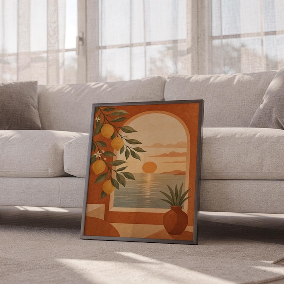 Mediterranean lemon and sea view arch print leaning against a white sofa in a bright living room with sheer curtains.