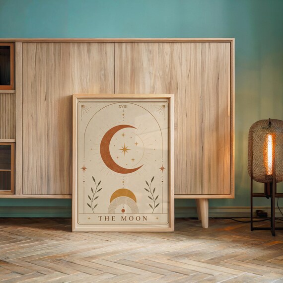 Mid century spiritual moon wall art framed on wooden console table against accent wall.