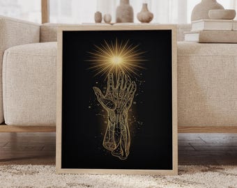 May include: A framed wall art print featuring a gold-toned anatomical hand illustration on a black background. The hand reaches upward toward a radiant golden starburst, surrounded by delicate celestial constellations and zodiac symbols.