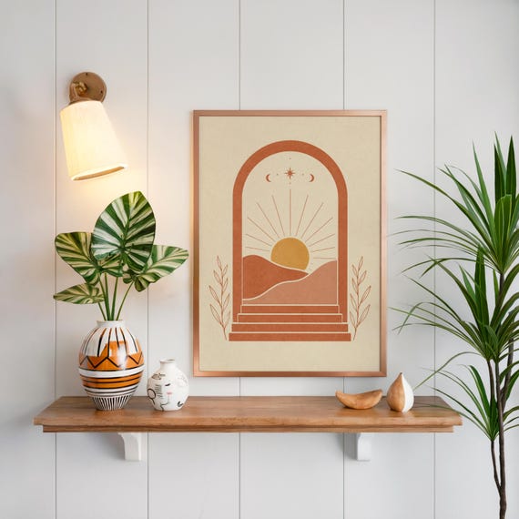 Boho desert wall art on floating wooden shelf above indoor green plants
